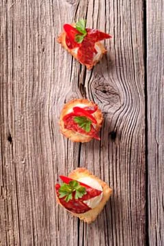 Mini appetizers with tomato basil topping on skewers Stock Photos