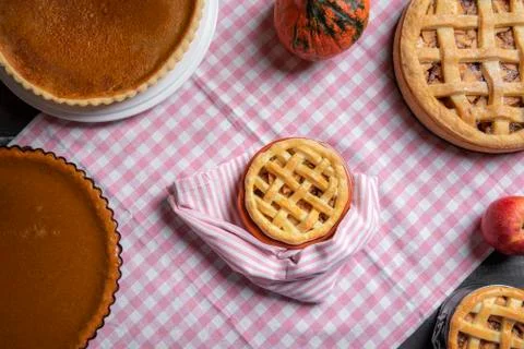 Mini apple pie surrounded by various pies. Above view. Sweet pastry. Stock Photos