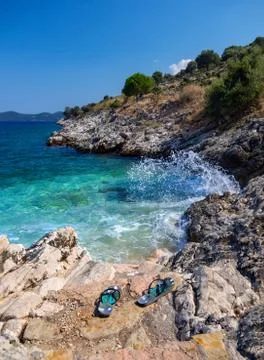Mini beach and flip flops with a beautiful view on the island of Kefalonia in Stock Photos