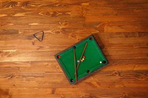 Mini billiard table with cue and balls. Mini snooker billiard game. Green bil Stock Photos