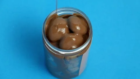 Mini biscuits with melted Cadbury chocolate sauce topping  Stock Footage 231861372