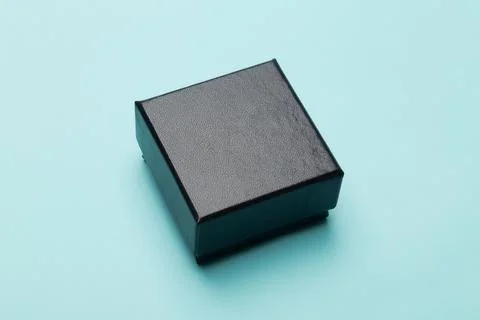 Mini black box product packaging isolated on blue background Stock Photos