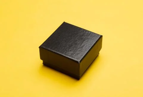Mini black box product packaging isolated on yellow background Stock Photos