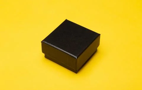 Mini black box product packaging isolated on yellow background Stock Photos