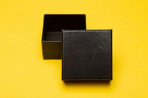 Mini black box product packaging isolated on yellow background Stock Photos