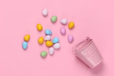 Mini bucket with easter eggs on a pink pastel background. Easter minimalism.  写真素材