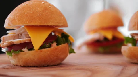 Mini Burger With Meat, Cheese and Fresh Vegetables on Wooden Board. Stock Footage 345781067