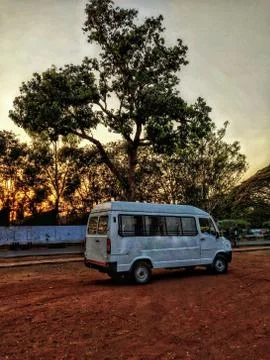 A Mini Bus parked under a tree. Stock Photos