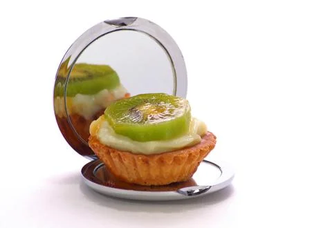 Mini Cake sitting on mirrored compact Stock Photos