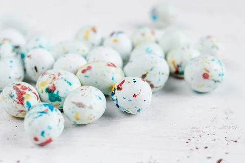Mini candy covered eggs in pastel colours. Stock Photos
