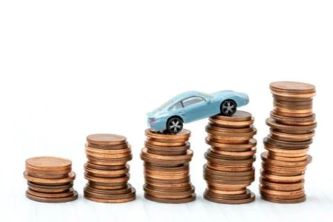 Mini car model on stack of coins Stock Photos