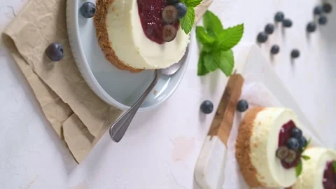 Mini cheesecake with berry compote and fresh blueberries on a plate Stock Footage 347537465