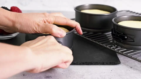 Mini cheesecakes close-up on kitchen table, just from the oven Video stock 258640262