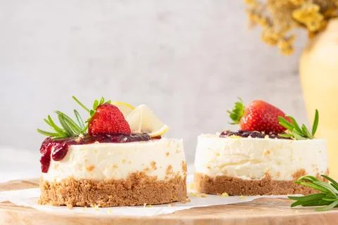 Mini cheesecakes topped with berry jam and fruit Stock Photos
