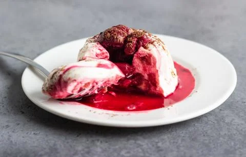 Mini chocolate cheesecake with raspberry sauce and mint. Stock Photos