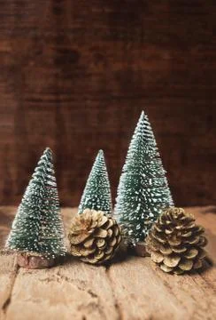 Mini christmas tree and pine cone wood on rustic wooden table and dark brown  Stock Photos