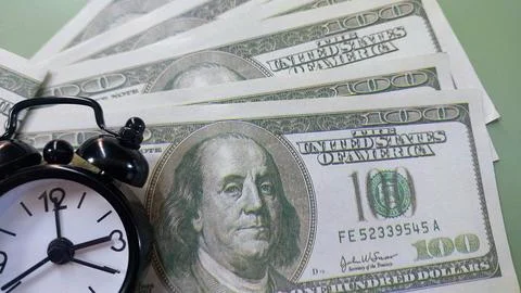 Mini clock and usd banknotes, time is money, Stock Photos