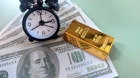 Mini clock, gold bars and usd banknotes, investment or savings, Stock Photos