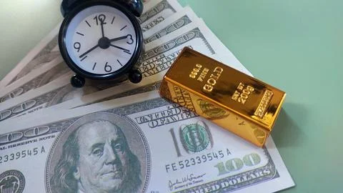 Mini clock, gold bars and usd banknotes, investment or savings, Stock Photos