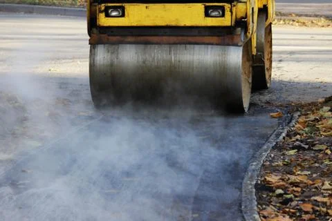 Mini compactor tires the upper layer of asphalt in the construction of a bicy Free Stock Photos