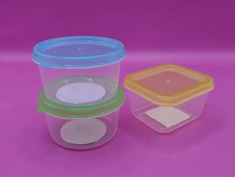 Mini containers on a bright purple background Stock Photos