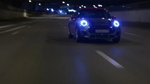 Mini Cooper drives at night. Sport car Stock Footage 211085486