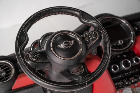 MINI Cooper steering wheel inside a red dashboard Foto stock