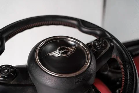 MINI Cooper steering wheel inside a red dashboard Stock-Fotos