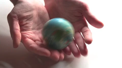 A mini copy of a globe lies in the hands closeup. The hand or hands are playi Stock Footage 152581540