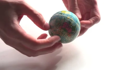 A mini copy of a globe lies in the hands closeup. The hand or hands are playi Stock Footage 152581654