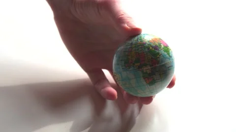 A mini copy of a globe lies in the hands closeup. The hand or hands are playi Stock Footage 152581870
