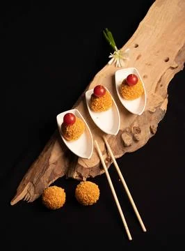 Mini crispy appetizer balls topped with cherry tomatoes Stock Photos