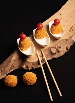 Mini crispy appetizer balls topped with cherry tomatoes Stock Photos