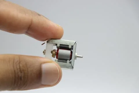 Mini DC motor of open frame type with a view of its various parts Stock Photos