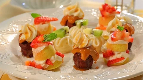 Mini desserts and sweets rotating on plate 2 Stock Footage 102136345