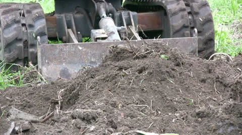 Mini digger bulldozer blade at work Stock Footage 25509798