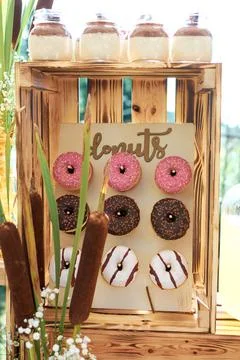 Mini donuts hang in a box. donuts in colored glaze. Fragment of the sweet tab Stock Photos