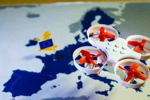 Mini drone flying over a EU map. European rules for drone aerial aircraft law Stock Photos