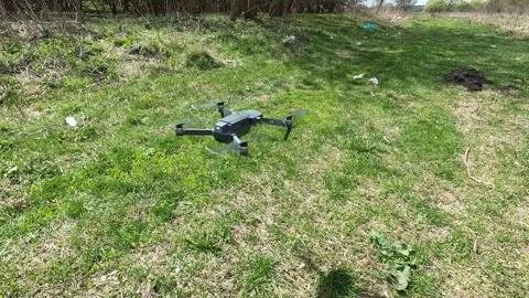 Mini drone unfolded on a grass before take-off. Stock Footage 164932626