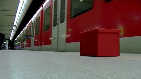 Mini DV - Stuttgart 2010: Metro Train Leaving, Red Box In The Foreground Stock Footage 104976553