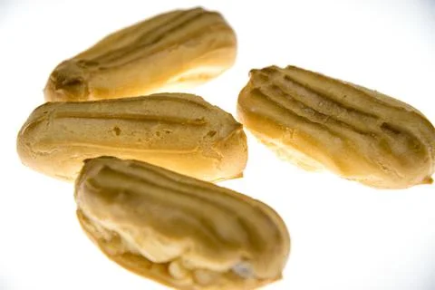 Mini eclairs on a white background. Stock Photos