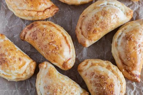 Mini empanadas stuffed with apple compote and cinnamon Stock Photos