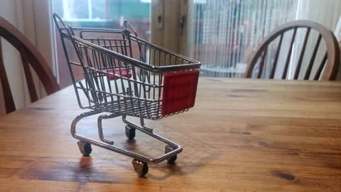 Mini empty shopping trolley online home delivery concept on kitchen table Video stock 164282677
