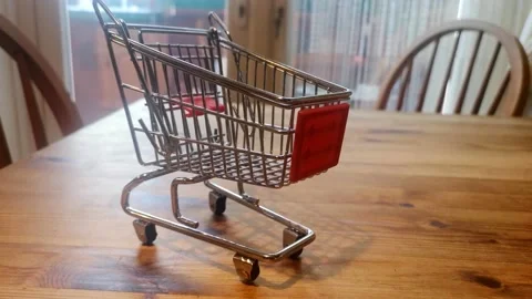 Mini empty shopping trolley online home delivery concept on kitchen table Video stock 164283867