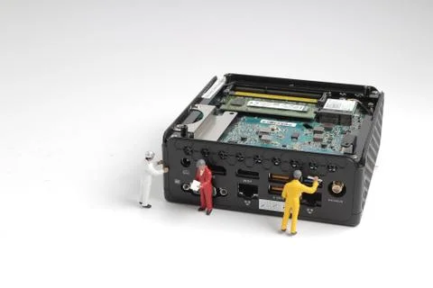 Mini engineers inspecting computer processor Stock Photos