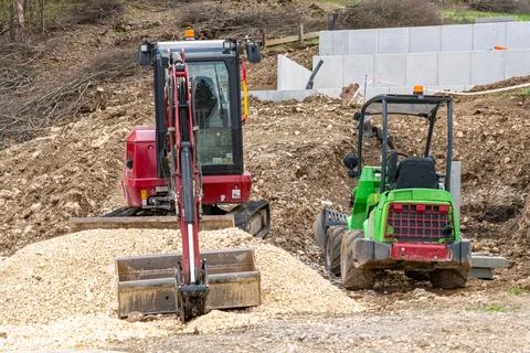 Mini excavator and compact loader on outdoor construction site Fotos Stock