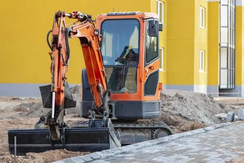 Mini excavator at the construction site. Compact construction equipment Stock-Fotos