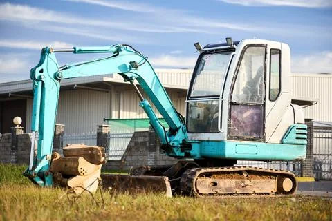 Mini excavator at construction site. Compact construction equipment for ope.. Stock Photos