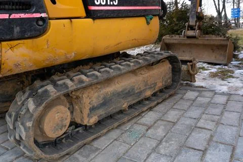 Mini excavator on the construction site. Replacement of paving slabs and re.. Stock Photos