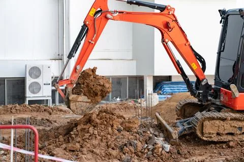 Mini excavator dig soil. Stock Photos